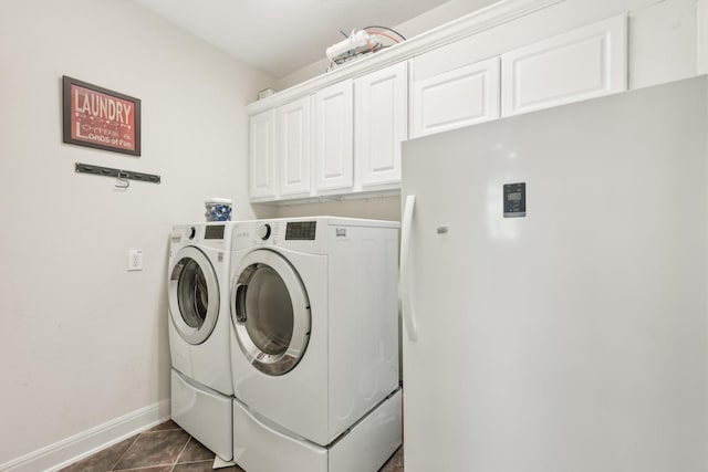 12106 Via Chianti Ct, Cypress, TX 77429 - laundry room featuring washing machine and clothes dryer, cabinet space, baseboards, and dark tile patterned floors