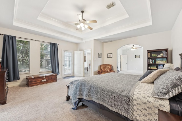12106 Via Chianti Ct, Cypress, TX 77429 - carpeted bedroom with a tray ceiling, access to exterior, arched walkways, baseboards, and ceiling fan