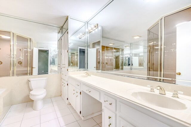3920 Blackberry Ln, Port Arthur, TX 77642 - bathroom featuring tile patterned flooring, a shower with shower door, toilet, a bathtub, and double vanity