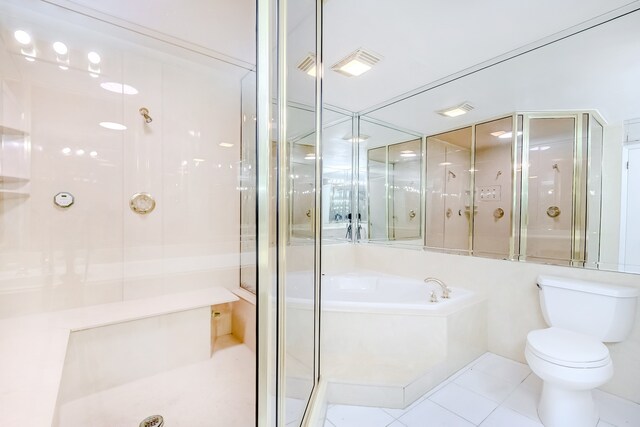 3920 Blackberry Ln, Port Arthur, TX 77642 - bathroom with tile patterned floors, a stall shower, toilet, and a garden tub