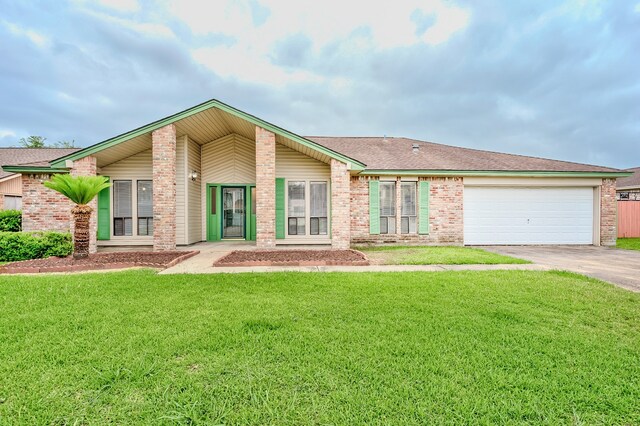 3920 Blackberry Ln, Port Arthur, TX 77642 - view of front of home featuring brick siding, concrete driveway, a garage, and a front yard