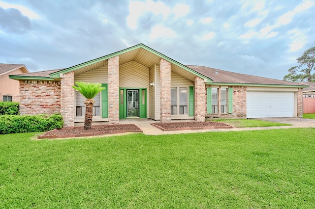 3920 Blackberry Ln, Port Arthur, TX 77642 - view of front facade featuring a front yard, driveway, a garage, and brick siding