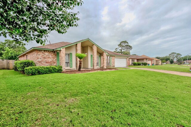 3920 Blackberry Ln, Port Arthur, TX 77642 - mid-century home featuring a garage, brick siding, and concrete driveway