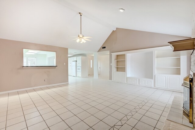 3920 Blackberry Ln, Port Arthur, TX 77642 - unfurnished living room featuring a fireplace with raised hearth, light tile patterned floors, beamed ceiling, high vaulted ceiling, and built in features