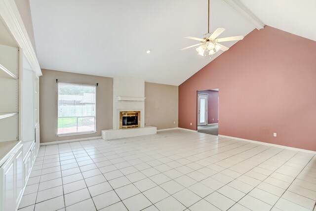 3920 Blackberry Ln, Port Arthur, TX 77642 - unfurnished living room with a ceiling fan, beam ceiling, high vaulted ceiling, baseboards, and a brick fireplace
