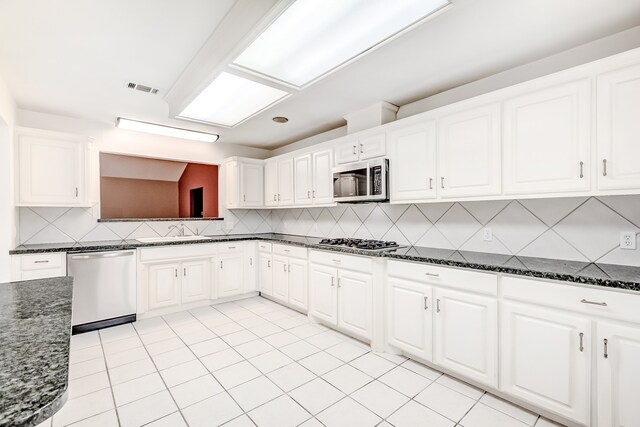 3920 Blackberry Ln, Port Arthur, TX 77642 - kitchen with stainless steel appliances, a sink, tasteful backsplash, and dark stone counters