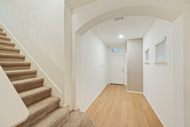 2827 Arica Ln, Spring, TX 77373 - foyer with arched walkways, light wood-style flooring, stairs, baseboards, and recessed lighting