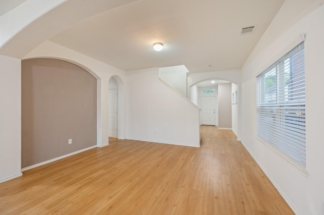 2827 Arica Ln, Spring, TX 77373 - unfurnished room featuring light wood finished floors, arched walkways, and baseboards