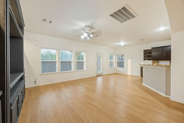 2827 Arica Ln, Spring, TX 77373 - unfurnished living room featuring light wood-type flooring, a ceiling fan, and baseboards