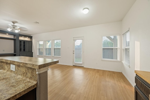 2827 Arica Ln, Spring, TX 77373 - kitchen featuring light wood-type flooring, baseboards, and a ceiling fan