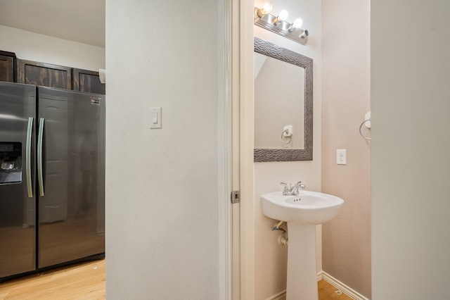 2827 Arica Ln, Spring, TX 77373 - bathroom featuring wood finished floors and a sink