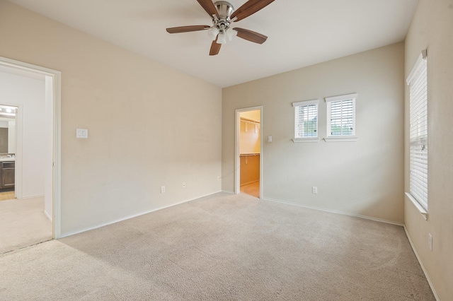 2827 Arica Ln, Spring, TX 77373 - unfurnished bedroom with light carpet, a walk in closet, baseboards, and ensuite bath