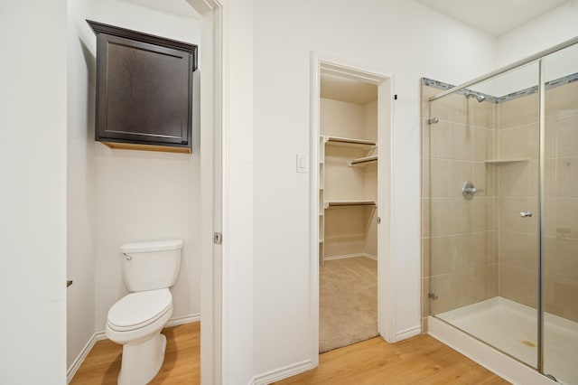 2827 Arica Ln, Spring, TX 77373 - full bath featuring wood finished floors, a shower stall, a spacious closet, and toilet