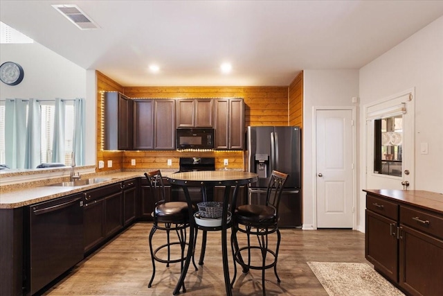 1685 Rd 5102, Cleveland, TX 77327 - kitchen with black appliances, light wood-type flooring, a sink, dark brown cabinets, and light countertops