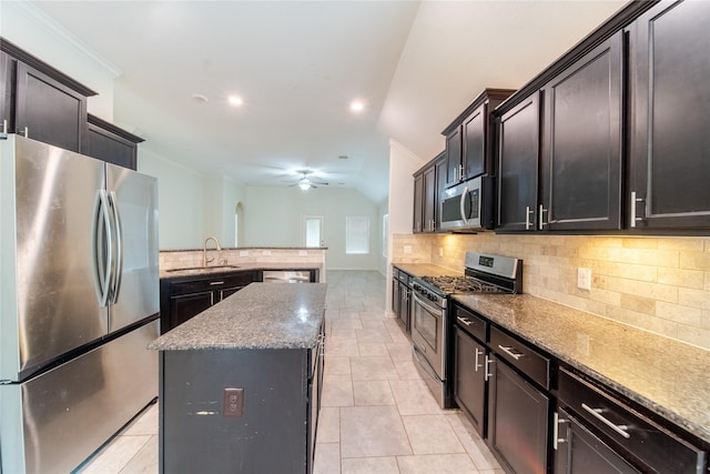 18423 Weeping Spring Dr, Cypress, TX 77429 - kitchen featuring appliances with stainless steel finishes, a sink, decorative backsplash, a center island, and a peninsula