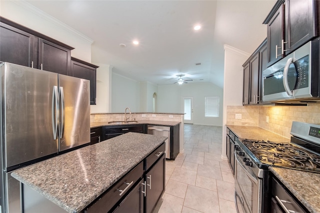 18423 Weeping Spring Dr, Cypress, TX 77429 - kitchen with appliances with stainless steel finishes, a sink, a peninsula, tasteful backsplash, and recessed lighting