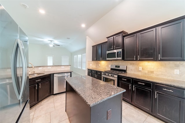 18423 Weeping Spring Dr, Cypress, TX 77429 - kitchen with appliances with stainless steel finishes, a sink, tasteful backsplash, a center island, and lofted ceiling