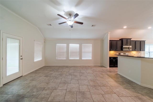 18423 Weeping Spring Dr, Cypress, TX 77429 - kitchen with stainless steel microwave, ceiling fan, lofted ceiling, backsplash, and ornamental molding