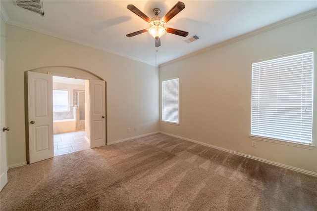 18423 Weeping Spring Dr, Cypress, TX 77429 - carpeted spare room with ceiling fan, crown molding, baseboards, and arched walkways
