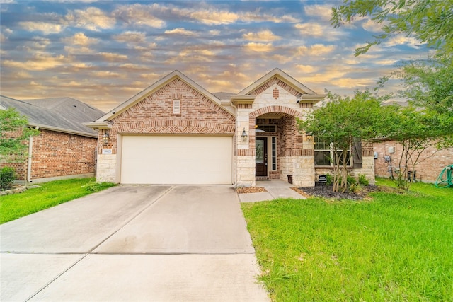 18423 Weeping Spring Dr, Cypress, TX 77429 - french country style house with driveway, an attached garage, brick siding, stone siding, and a front lawn