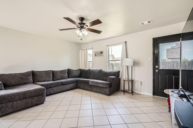503 Savory Ln, Crosby, TX 77532 - living area featuring ceiling fan, light tile patterned floors, and baseboards
