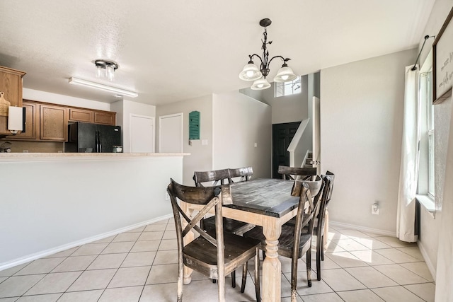 503 Savory Ln, Crosby, TX 77532 - dining area with light tile patterned floors, a chandelier, and baseboards