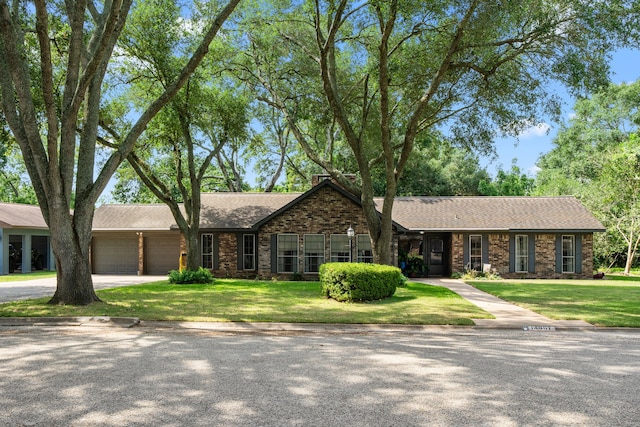 14907 River Oaks Dr, East Bernard, TX 77435 - single story home with brick siding, a garage, a front lawn, driveway, and a shingled roof