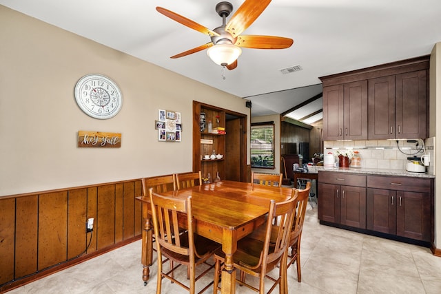 14907 River Oaks Dr, East Bernard, TX 77435 - dining room featuring ceiling fan, wainscoting, and wood walls