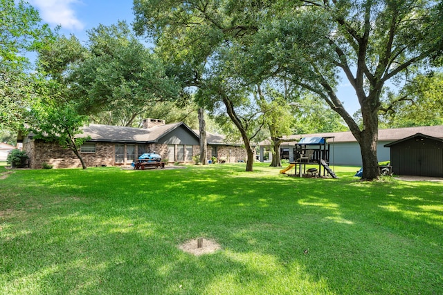 14907 River Oaks Dr, East Bernard, TX 77435 - view of grassy yard with a playground