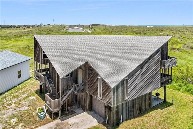 635 Lantana Dr, Port Aransas, TX 78373 - view of front of home with a shingled roof and an outdoor structure
