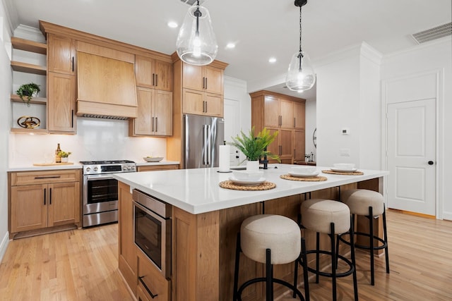 26 Riva Row, The Woodlands, TX 77380 - kitchen with stainless steel appliances, premium range hood, open shelves, light wood-style floors, and ornamental molding