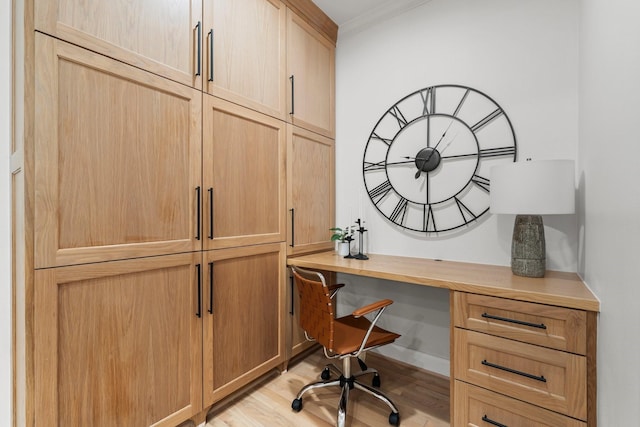 26 Riva Row, The Woodlands, TX 77380 - office with built in desk, light wood-type flooring, and crown molding
