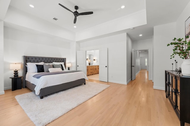 26 Riva Row, The Woodlands, TX 77380 - bedroom with light wood finished floors, baseboards, recessed lighting, ensuite bath, and ceiling fan