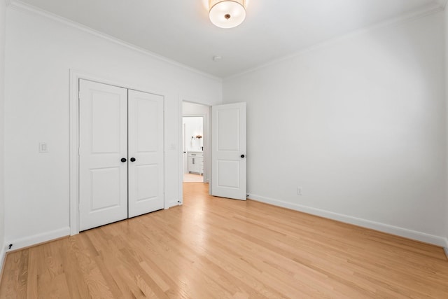26 Riva Row, The Woodlands, TX 77380 - unfurnished bedroom featuring ornamental molding, light wood-style flooring, baseboards, and a closet