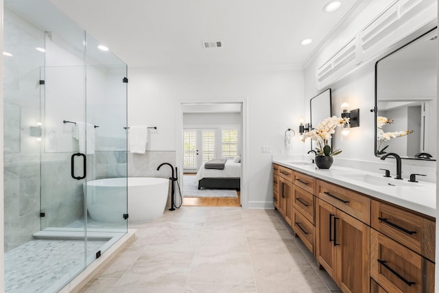 26 Riva Row, The Woodlands, TX 77380 - ensuite bathroom featuring a stall shower, double vanity, french doors, a freestanding tub, and recessed lighting
