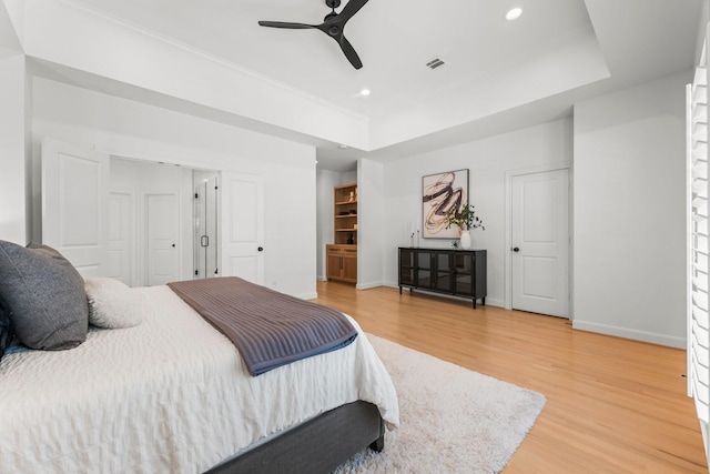 26 Riva Row, The Woodlands, TX 77380 - bedroom with light wood finished floors, baseboards, recessed lighting, a raised ceiling, and ceiling fan