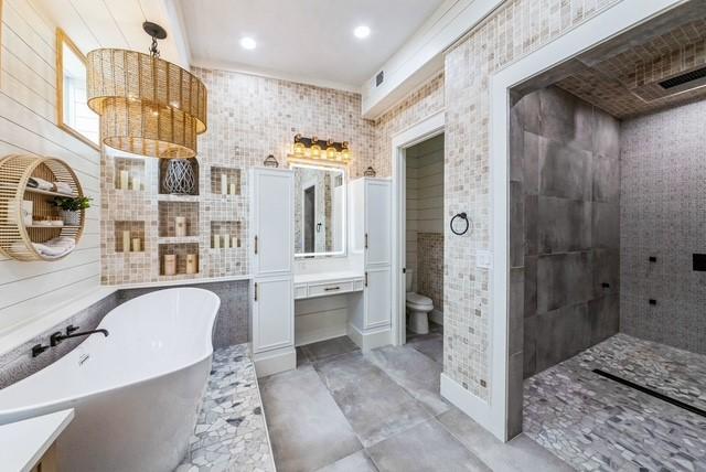 209 Horse Shoe Trl, Angleton, TX 77515 - full bathroom with tile walls, a freestanding bath, toilet, vanity, and a tile shower