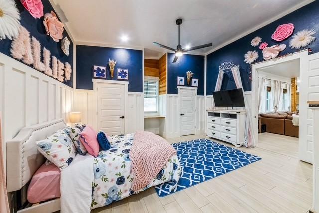209 Horse Shoe Trl, Angleton, TX 77515 - bedroom featuring a wainscoted wall, ornamental molding, wood finished floors, recessed lighting, and a decorative wall