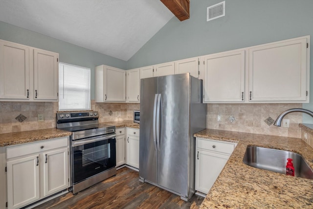 286 Ling St, Bayou Vista, TX 77563 - kitchen with appliances with stainless steel finishes, a sink, dark wood-style floors, white cabinetry, and decorative backsplash