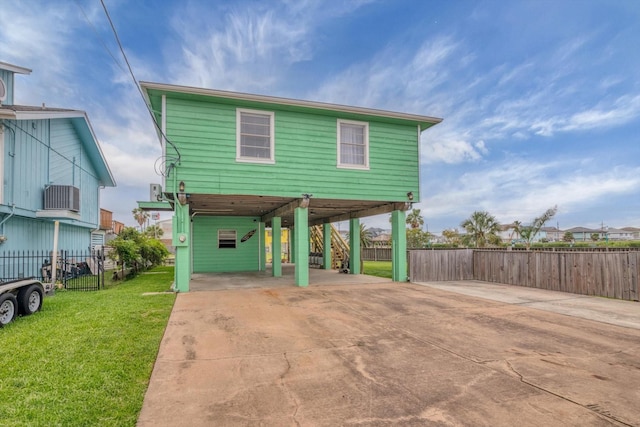 286 Ling St, Bayou Vista, TX 77563 - raised beach house featuring a carport, driveway, and stairway