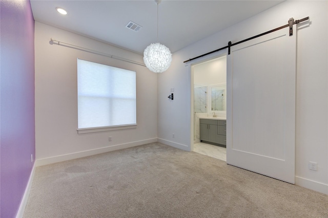 8964 Zurcher Ln, Houston, TX 77080 - carpeted empty room with a barn door, baseboards, and recessed lighting