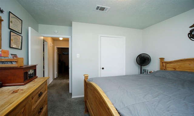 12662 Hackberry Dr, Willis, TX 77318 - bedroom with dark colored carpet, a textured ceiling, and baseboards