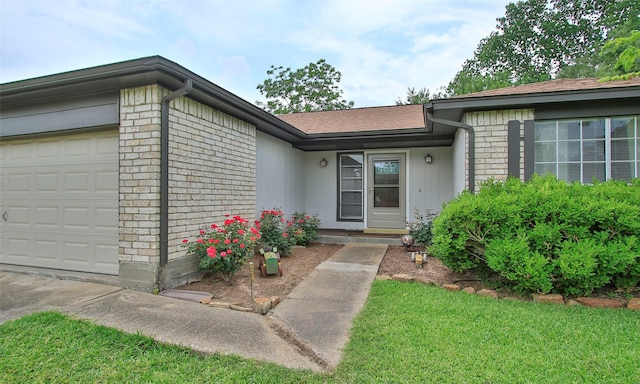 12662 Hackberry Dr, Willis, TX 77318 - doorway to property featuring a garage and brick siding