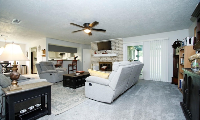 12662 Hackberry Dr, Willis, TX 77318 - carpeted living room with a ceiling fan, a brick fireplace, and a textured ceiling