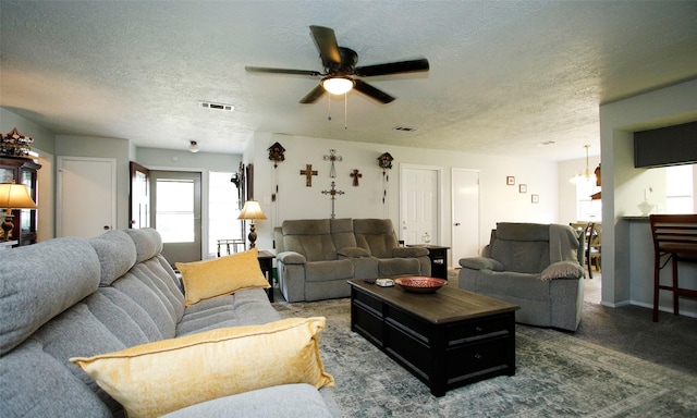 12662 Hackberry Dr, Willis, TX 77318 - carpeted living room with ceiling fan, a textured ceiling, and a chandelier