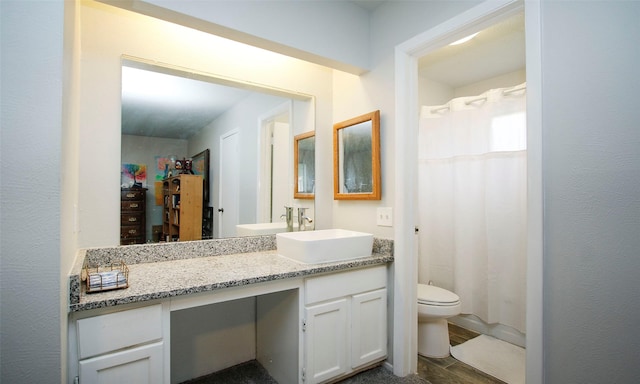 12662 Hackberry Dr, Willis, TX 77318 - full bath with toilet, vanity, and wood finished floors