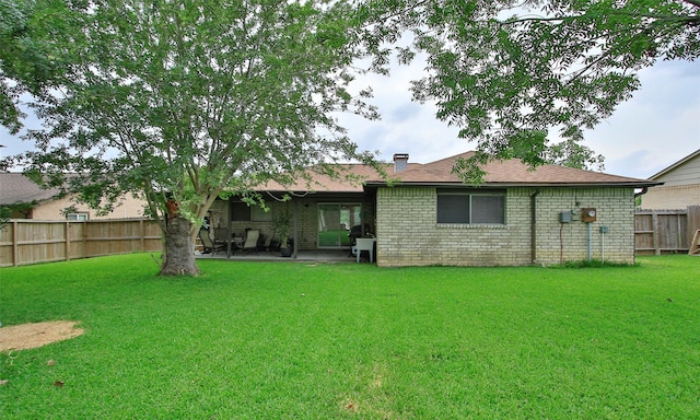 12662 Hackberry Dr, Willis, TX 77318 - rear view of house with brick siding, a patio area, and a chimney