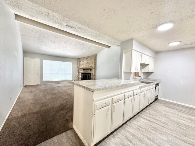 4515 Mossygate Dr, Spring, TX 77373 - kitchen featuring a textured ceiling, dishwashing machine, baseboards, light countertops, and white cabinets