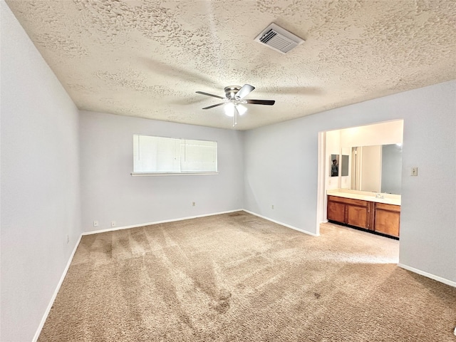 4515 Mossygate Dr, Spring, TX 77373 - unfurnished bedroom featuring light colored carpet, a textured ceiling, ensuite bathroom, baseboards, and ceiling fan