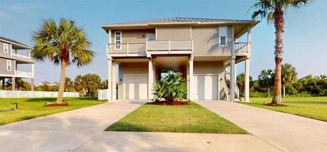 13830 Windlass Cir, Galveston, TX 77554 - raised beach house with a balcony, a standing seam roof, an attached garage, driveway, and metal roof